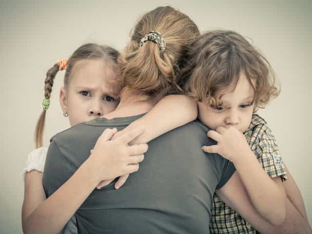 Mother holding two children